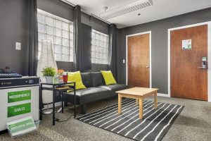 Lounge area with mixer, doors, table, and filing cabinet.