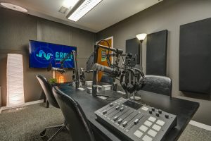 Podcast studio with Microphones, Headphones, TV, and chairs