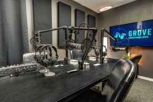 Podcast studio with Microphones, Headphones, TV, and chairs