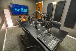 Podcast studio with Microphones, Headphones, TV, and chairs